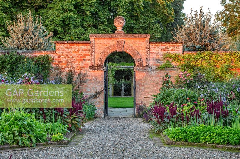 Porte dans le jardin potager clos avec des parterres d'Amaranthus - Morton Hall Gardens, Worcestershire