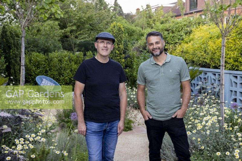 Designers Nick Gough et Douglas Vieira debout dans un jardin contemporain qu'ils ont conçu