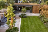 Vue aérienne du jardin de banlieue contemporain avec pergola et salon de jardin ou bureau avec Acer rufinerve en premier plan