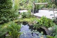 Jardin tropical en août avec bassin